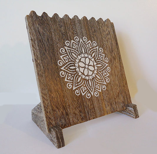 wooden necklace display with painted white mandala
